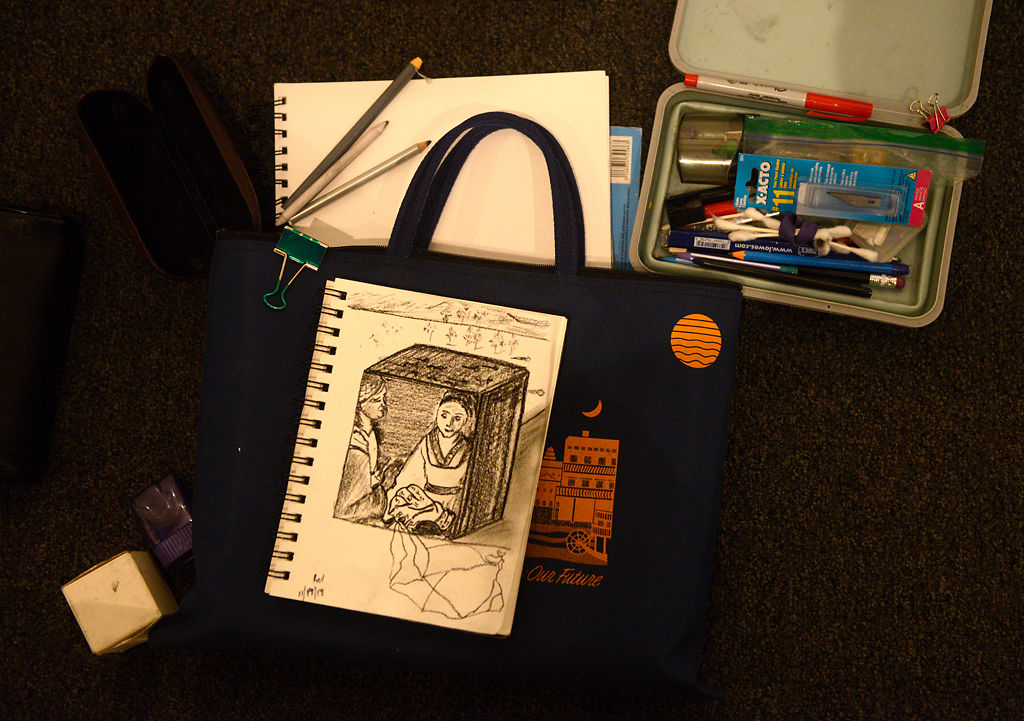 A sketch of Salvador Dali's Caring for a Surrealistic Watch made by Luke Lucas lies among Lucas' personal art materials Tuesday at the Museum of Art and Archaeology